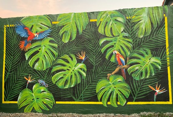 Rainforest wall mural with parrots and Bird of Paradise flowers